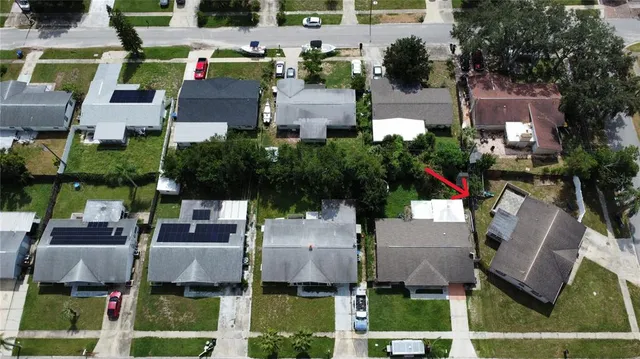 a aerial view of multiple houses with yard