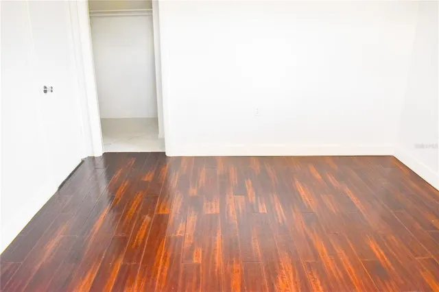 a view of a room with wooden floor