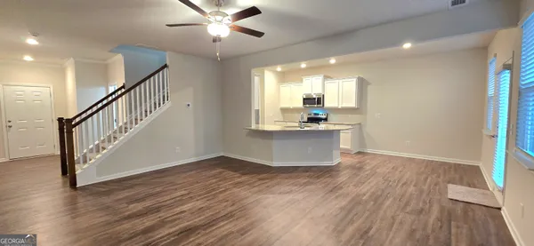 a view of kitchen with sink and wooden floor