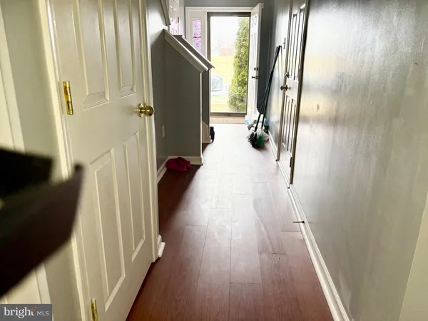 a view of hallway with wooden floor