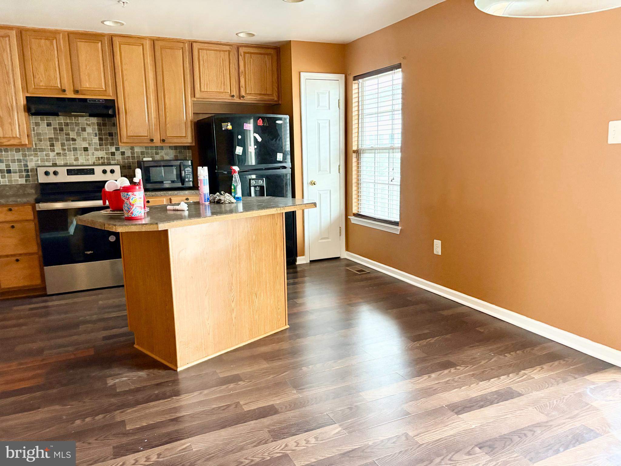 927 Tipton Road Baltimore, MD 21220 - Photo 14 of 21 a kitchen with counter top space and wooden floor
