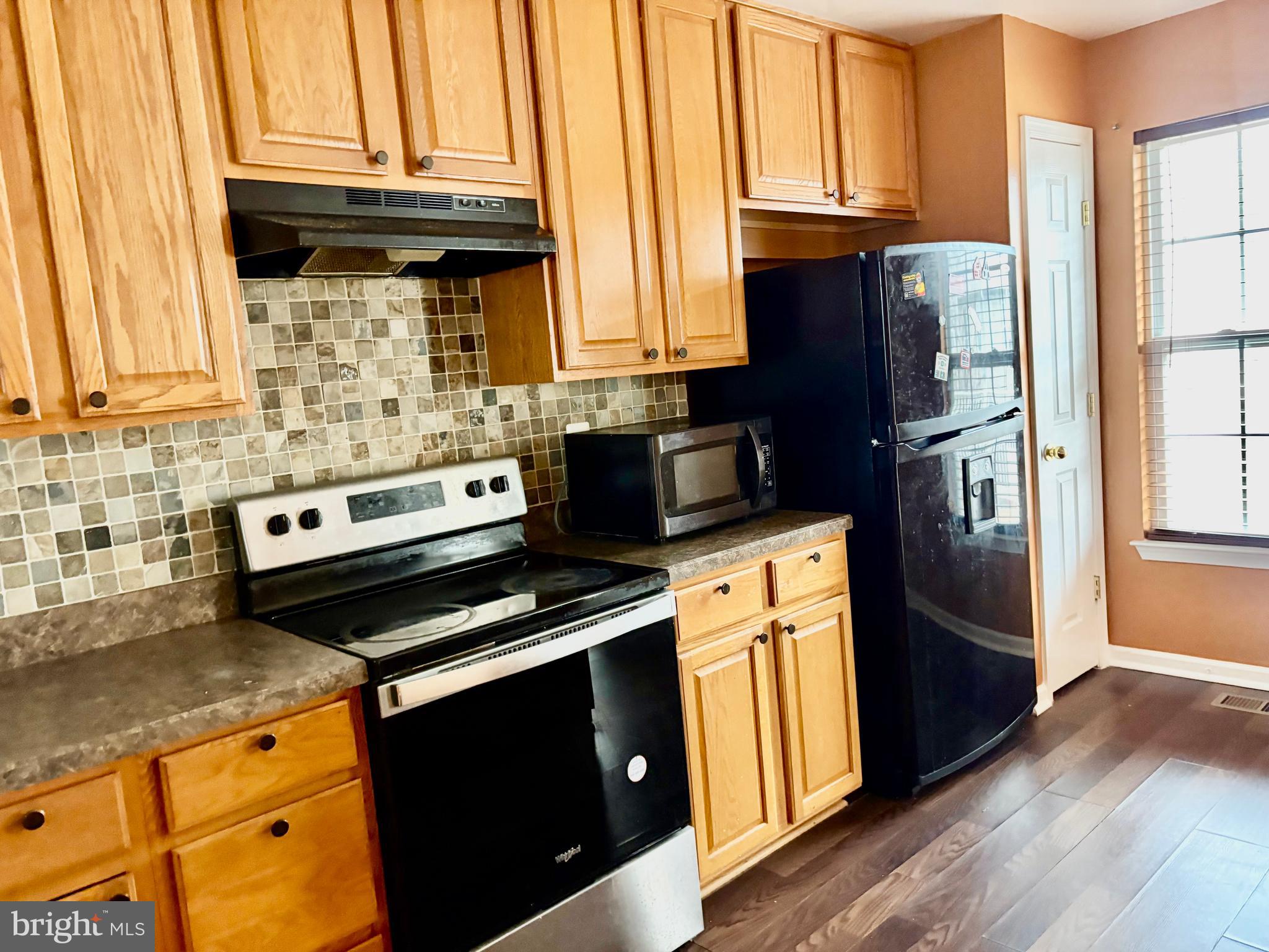 927 Tipton Road Baltimore, MD 21220 - Photo 15 of 21 a kitchen with stainless steel appliances granite countertop a refrigerator stove and sink