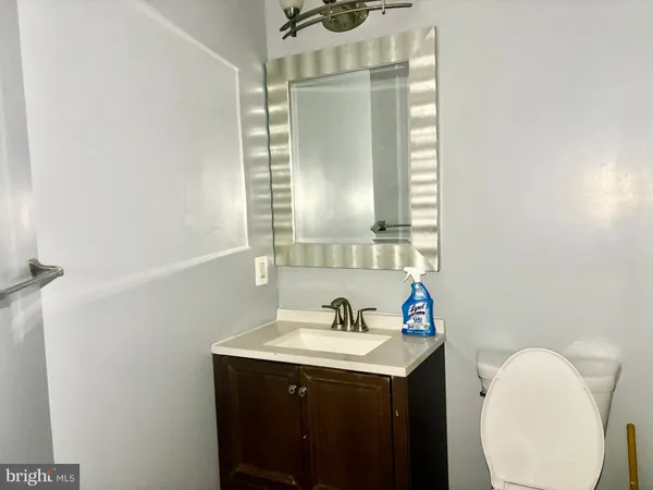 a bathroom with a sink vanity and a mirror