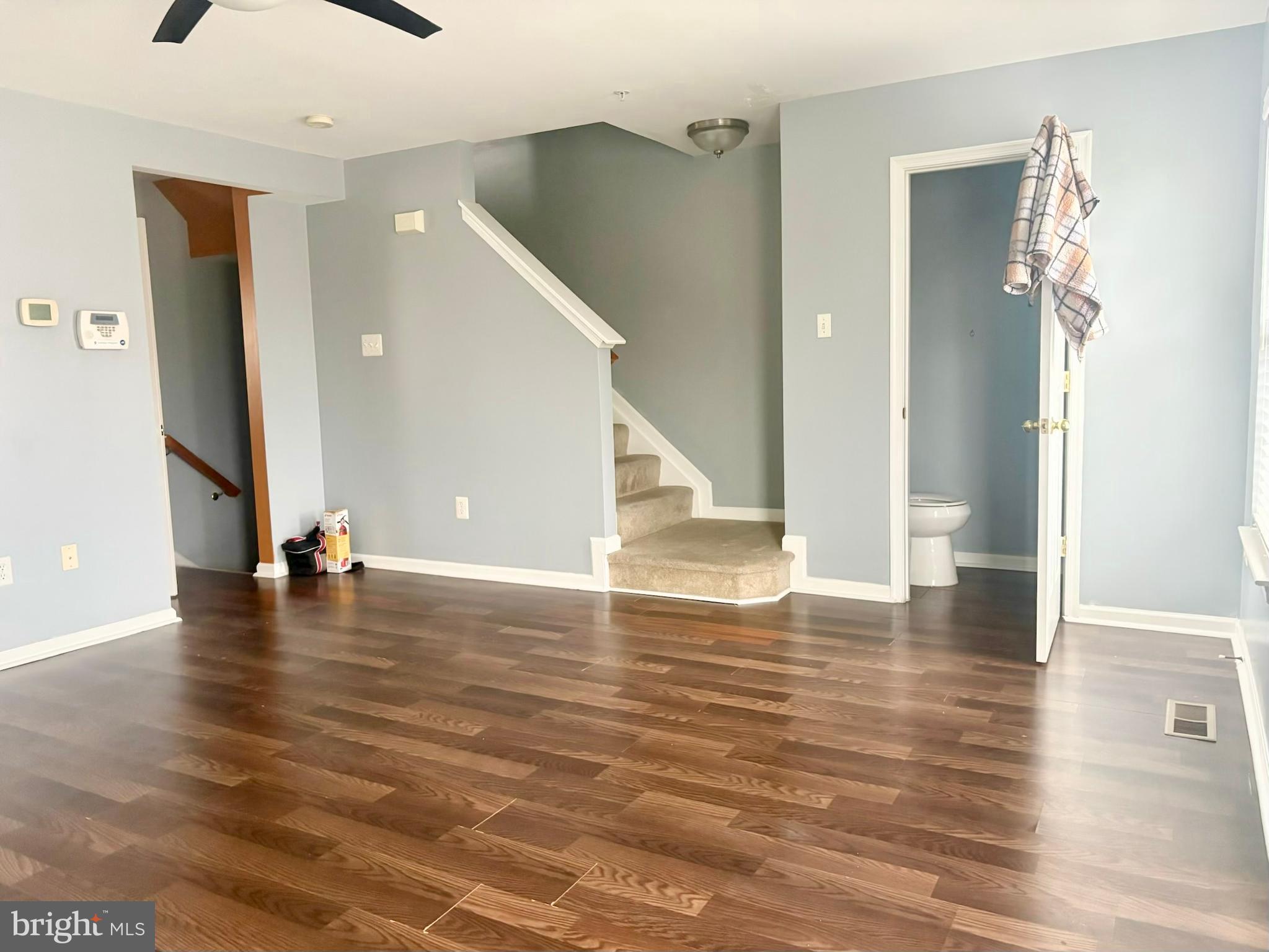 927 Tipton Road Baltimore, MD 21220 - Photo 19 of 21 a view of a room with wooden floor and staircase