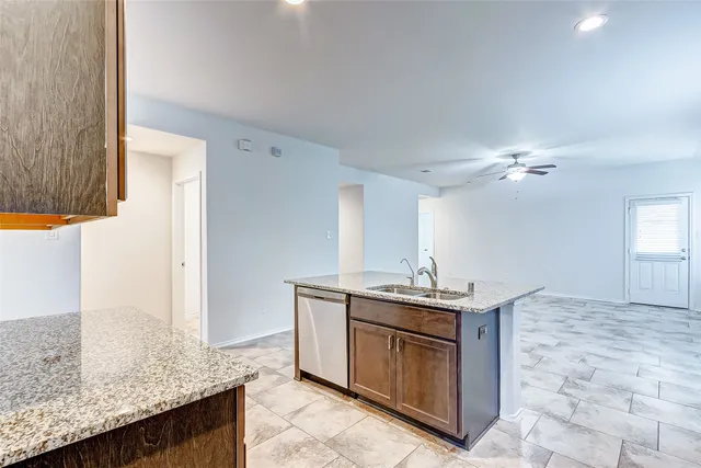 a kitchen with stainless steel appliances granite countertop a sink and a stove