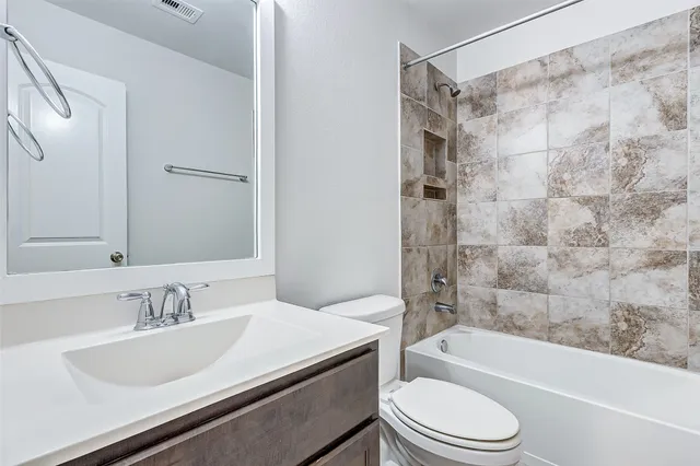 a bathroom with a sink a toilet and a bathtub