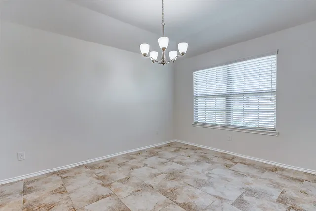 a view of a chandelier fan and a window