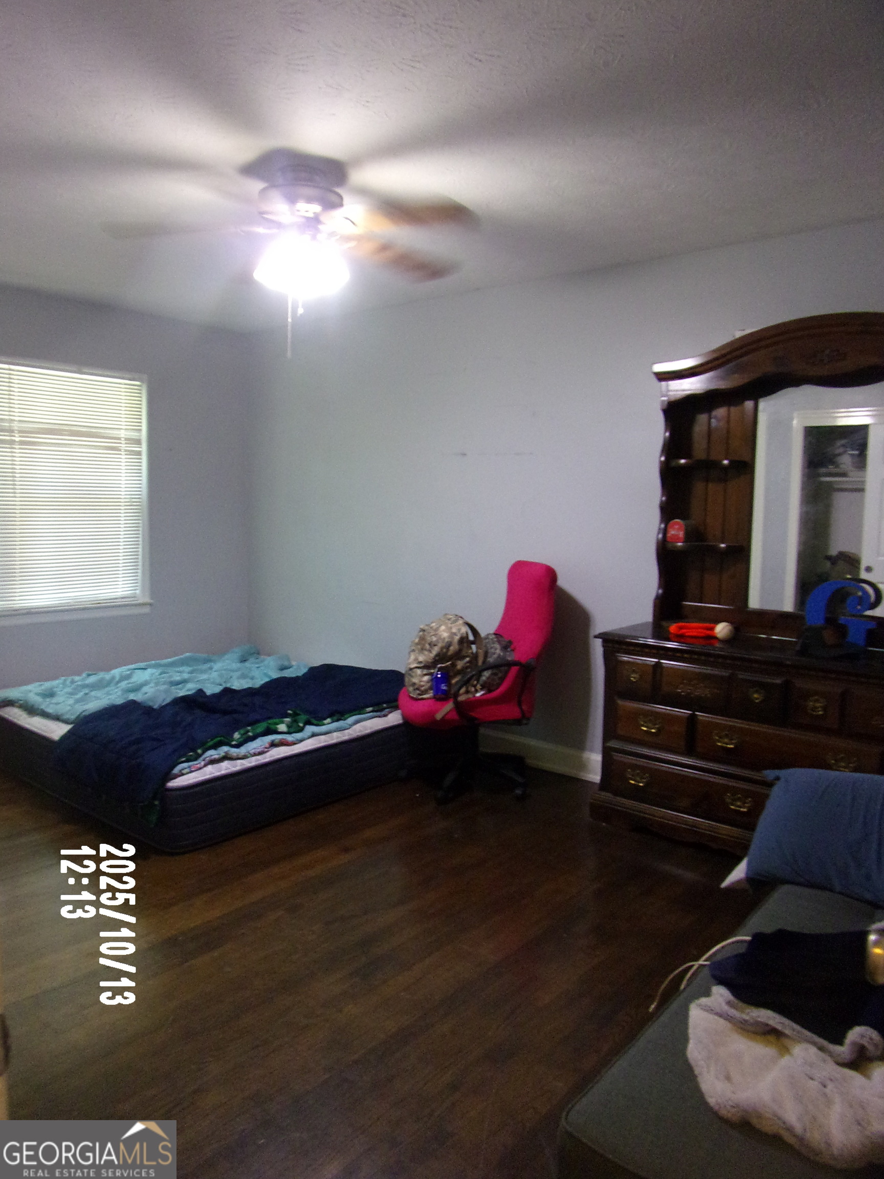 133 Springdale Drive Thomaston, GA 30286 - Photo 12 of 40 a bedroom with a bed and a chandelier