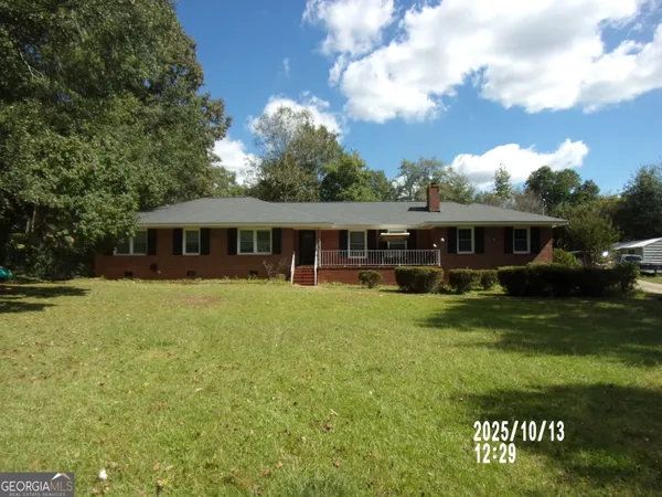 a front view of house with a garden and patio