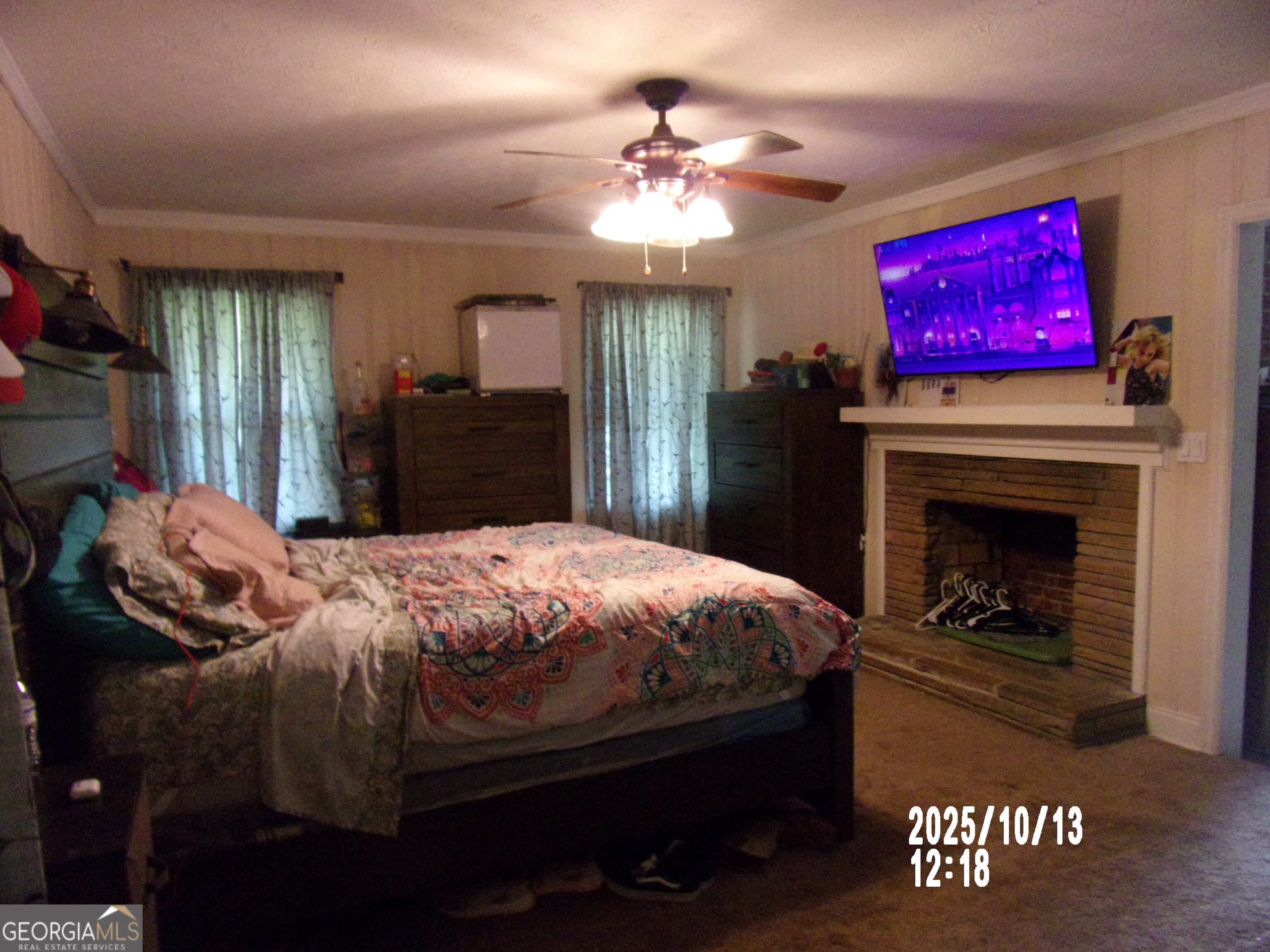 133 Springdale Drive Thomaston, GA 30286 - Photo 23 of 40 a bedroom with a bed and a fireplace