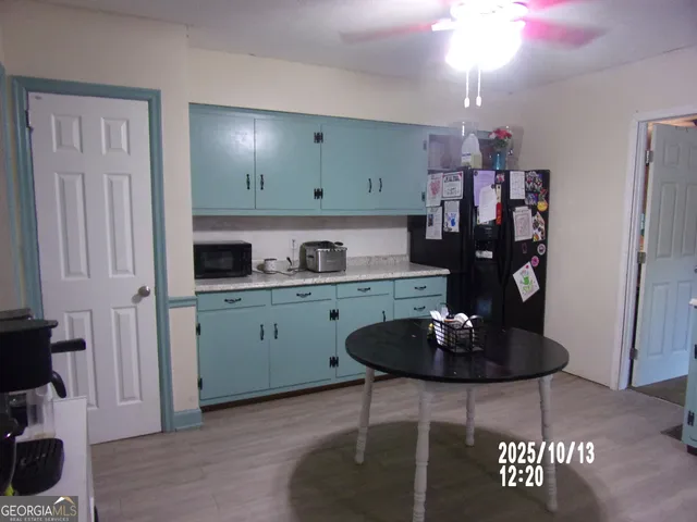 a kitchen with stainless steel appliances granite countertop a refrigerator and a stove