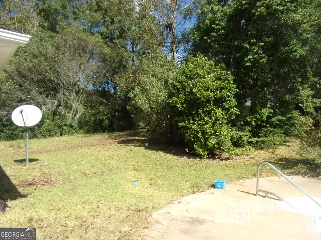 a front view of house with yard barbeque and outdoor seating