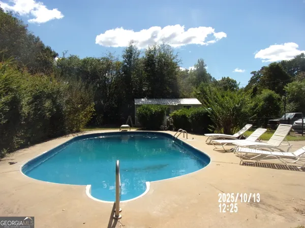 a view of a swimming pool with a yard