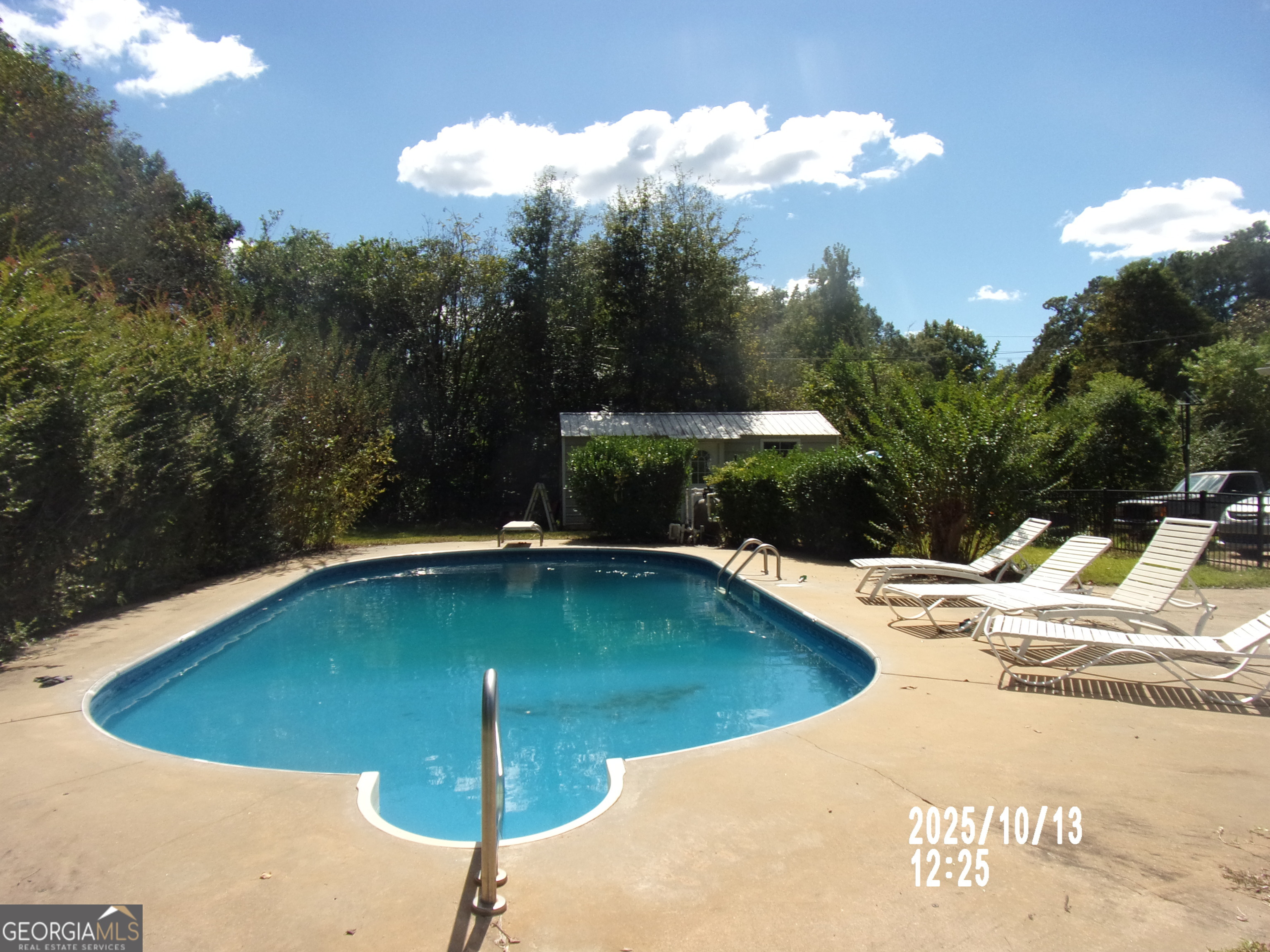 133 Springdale Drive Thomaston, GA 30286 - Photo 4 of 40 a view of a swimming pool with a yard