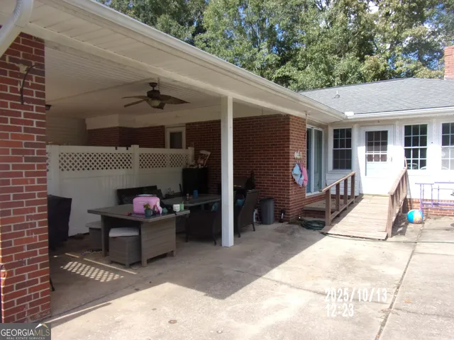 a view of a patio with table and chairs a barbeque