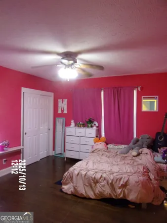 a living room with furniture a window and a flat screen tv