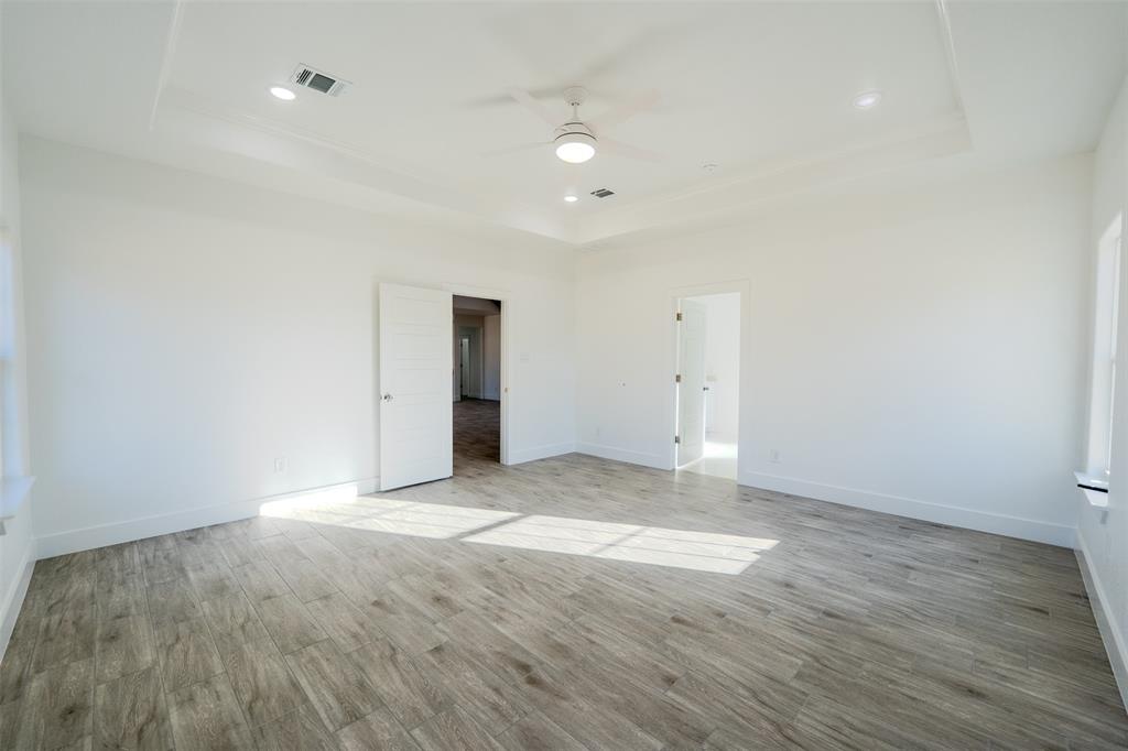 200 Kilkenny Road Poolville, TX 76487 - Photo 14 of 36 an empty room with wooden floor and windows