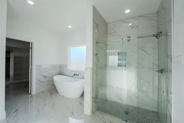 a bathroom with a bathtub and shower