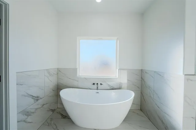 a white bath tub sitting in a bathroom