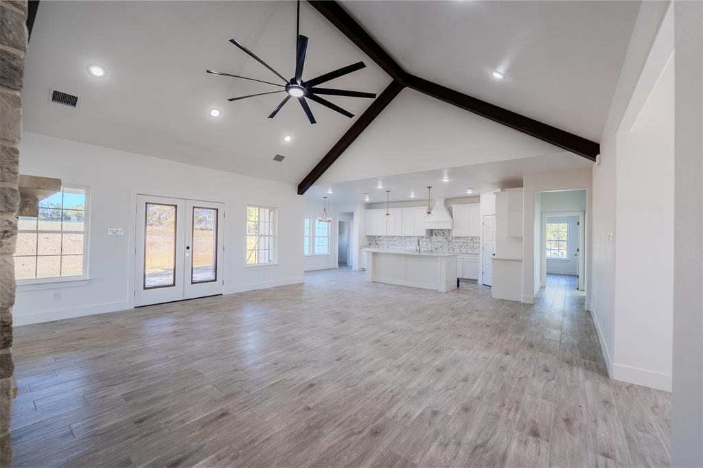 200 Kilkenny Road Poolville, TX 76487 - Photo 2 of 36 a view of empty room with wooden floor and window