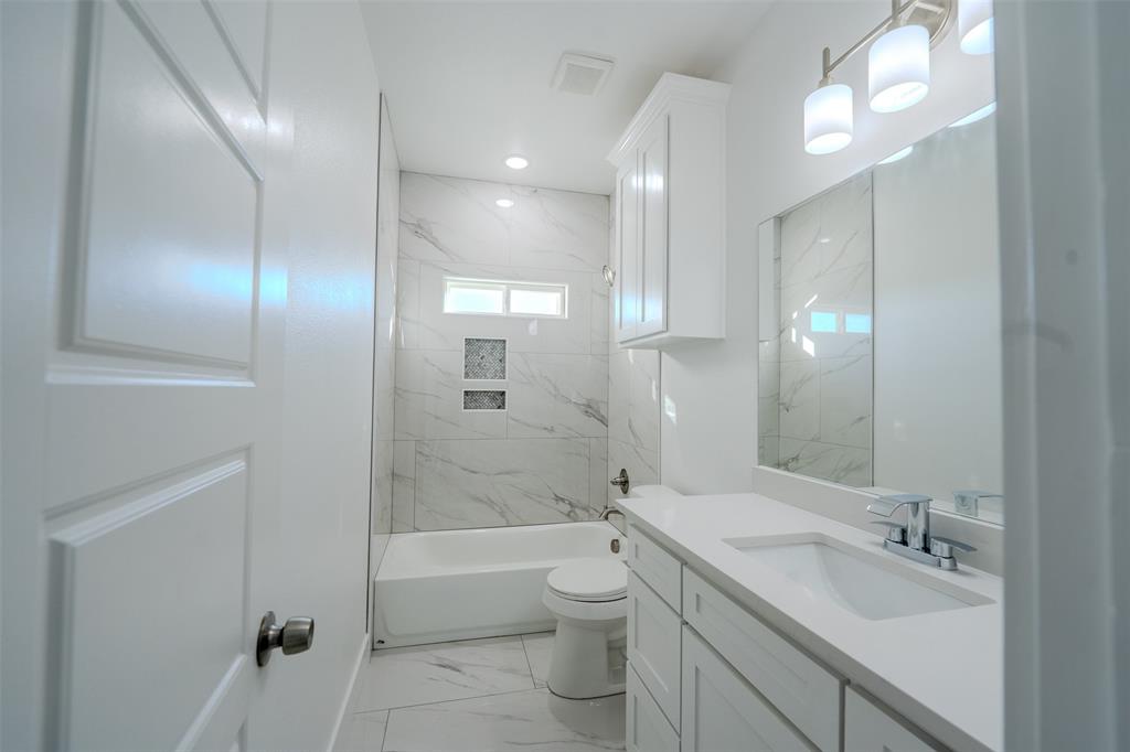 200 Kilkenny Road Poolville, TX 76487 - Photo 27 of 36 a bathroom with a double vanity sink toilet and shower