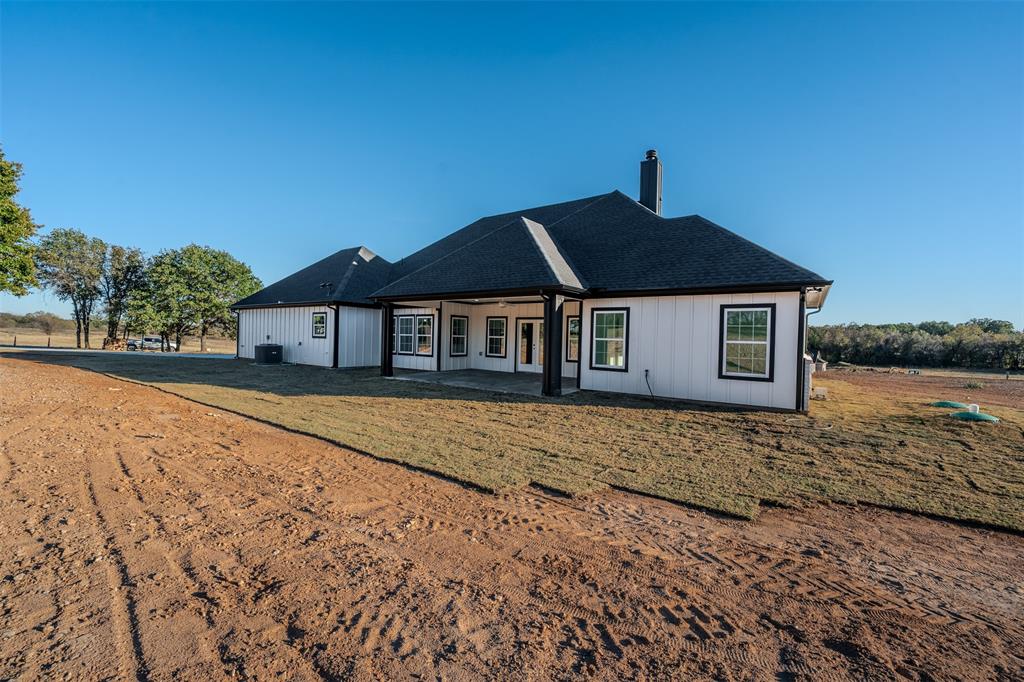 200 Kilkenny Road Poolville, TX 76487 - Photo 27 of 30 Back of property featuring a patio, a chimney, and a shingled roof