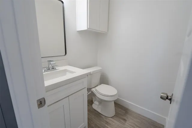 a bathroom with a sink toilet and a mirror