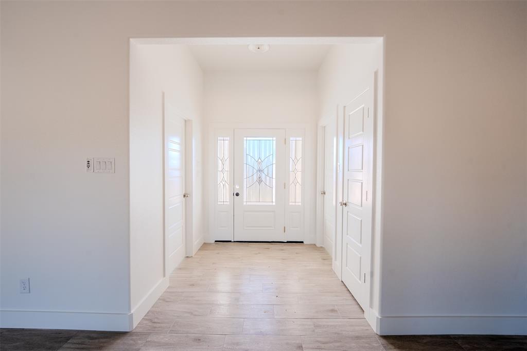 200 Kilkenny Road Poolville, TX 76487 - Photo 8 of 36 a view of a hallway with wooden floor