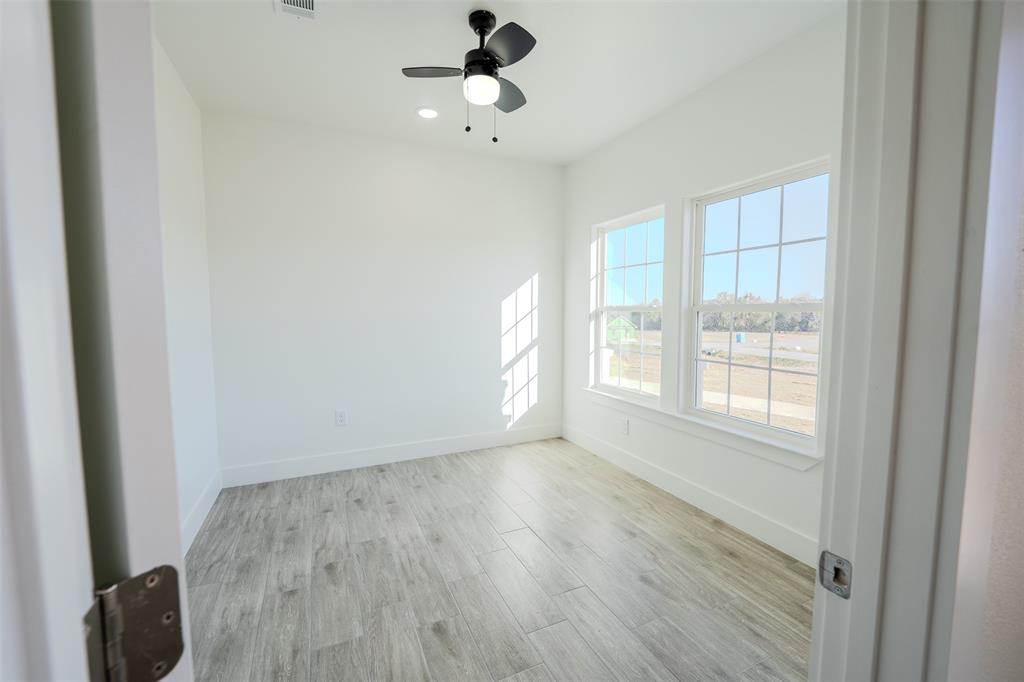 200 Kilkenny Road Poolville, TX 76487 - Photo 9 of 36 a view of an empty room with wooden floor and a window