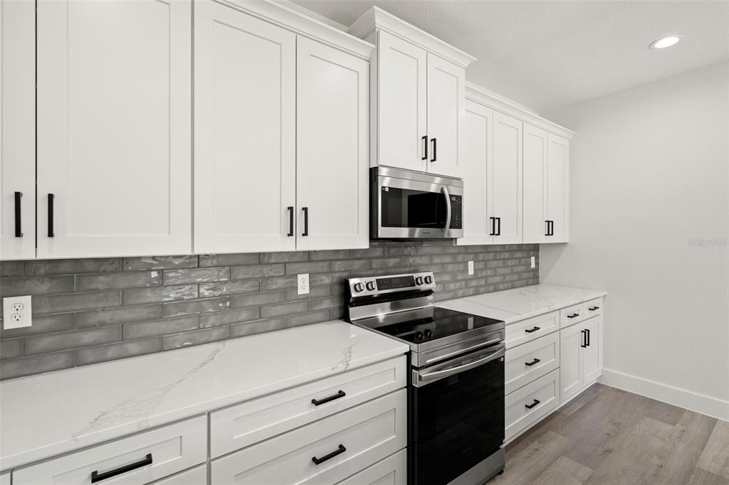 11810 North Providence Way Citrus Springs, FL 34433 - Photo 11 of 53 a kitchen with white cabinets and white appliances