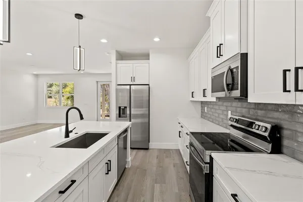 a kitchen with a stove and a microwave