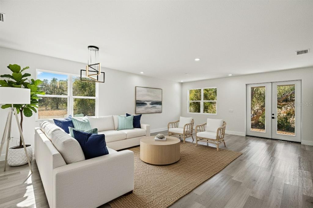 11810 North Providence Way Citrus Springs, FL 34433 - Photo 22 of 53 a living room with furniture a window and wooden floor
