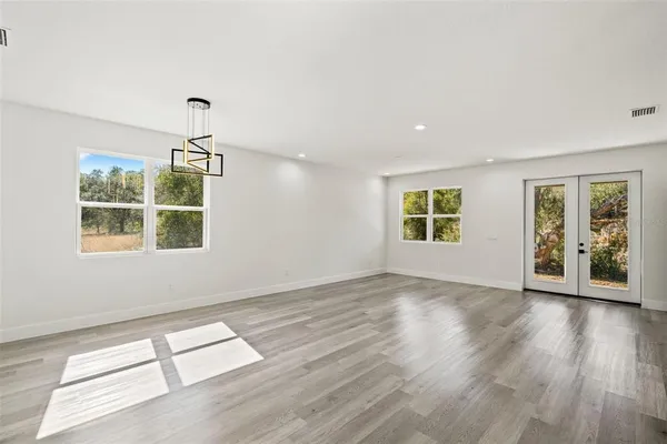 an empty room with wooden floor and a window