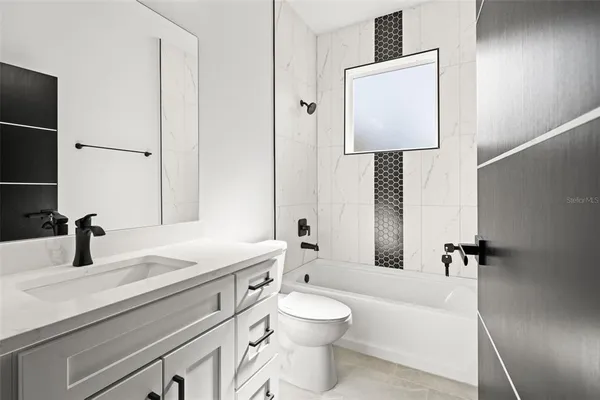 a bathroom with a toilet sink and a mirror