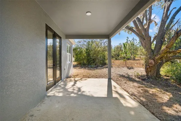 a view of a house with a yard and pathway