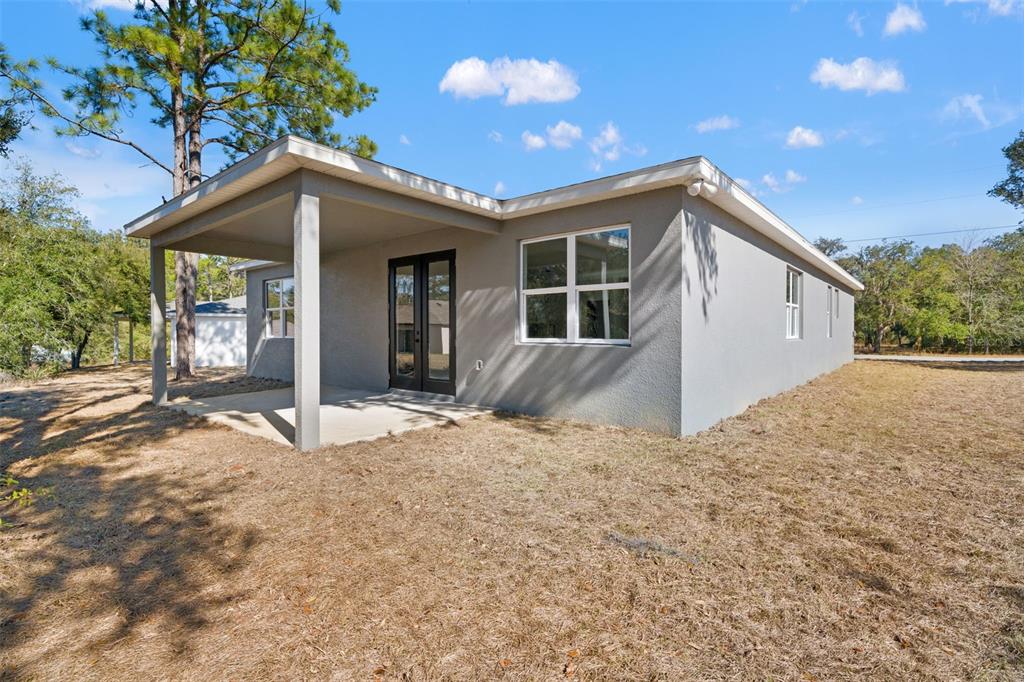 11810 North Providence Way Citrus Springs, FL 34433 - Photo 50 of 53 a house with trees in front of it