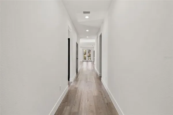 a view of hallway with wooden floor