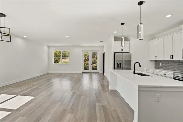 a kitchen with white cabinets and white appliances