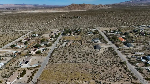 an aerial view of residential house and sandy dunes