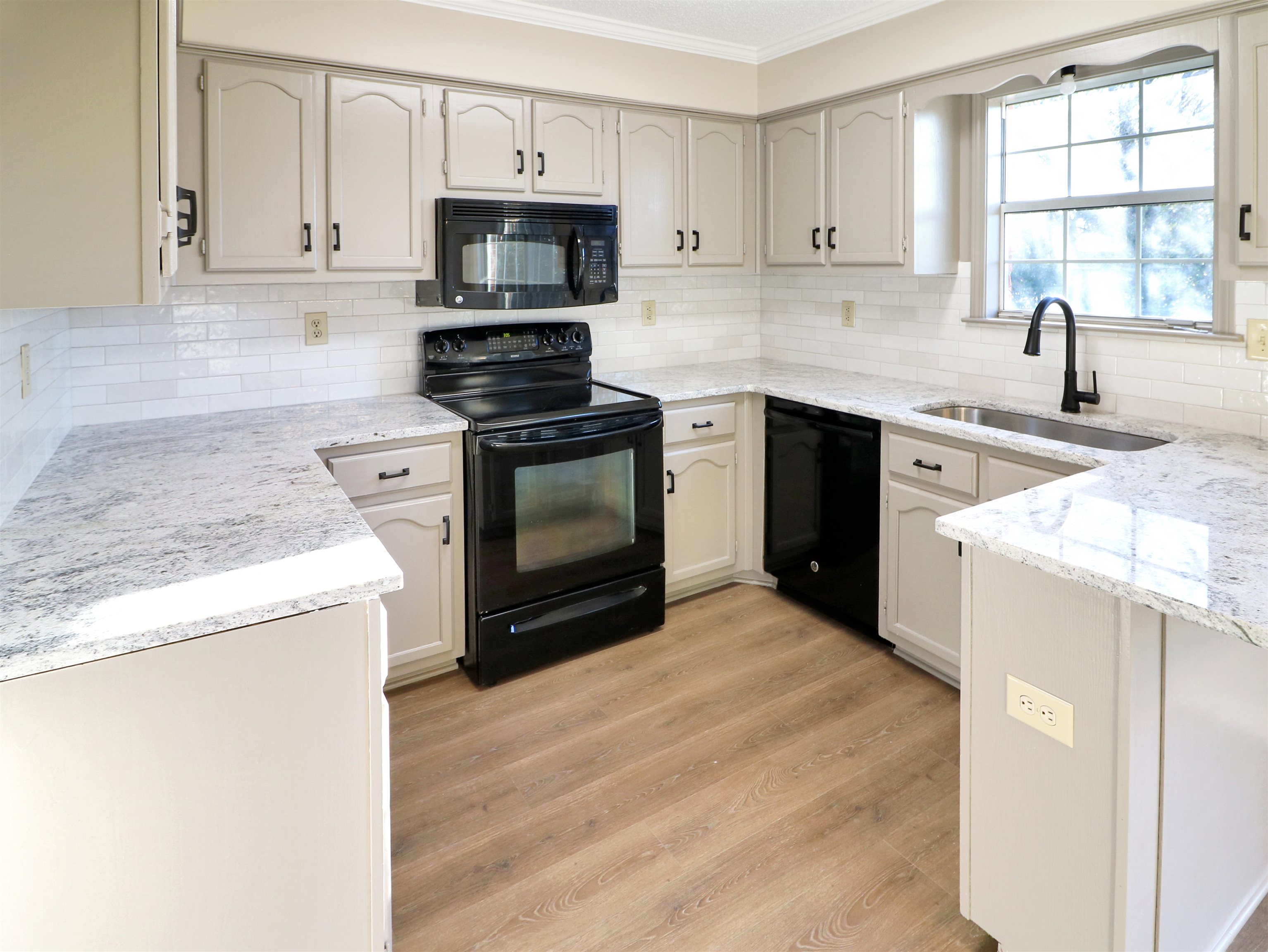 2321 Valley Edge Cove Memphis, TN 38016 - Photo 5 of 18 a kitchen with a sink stove top oven and microwave