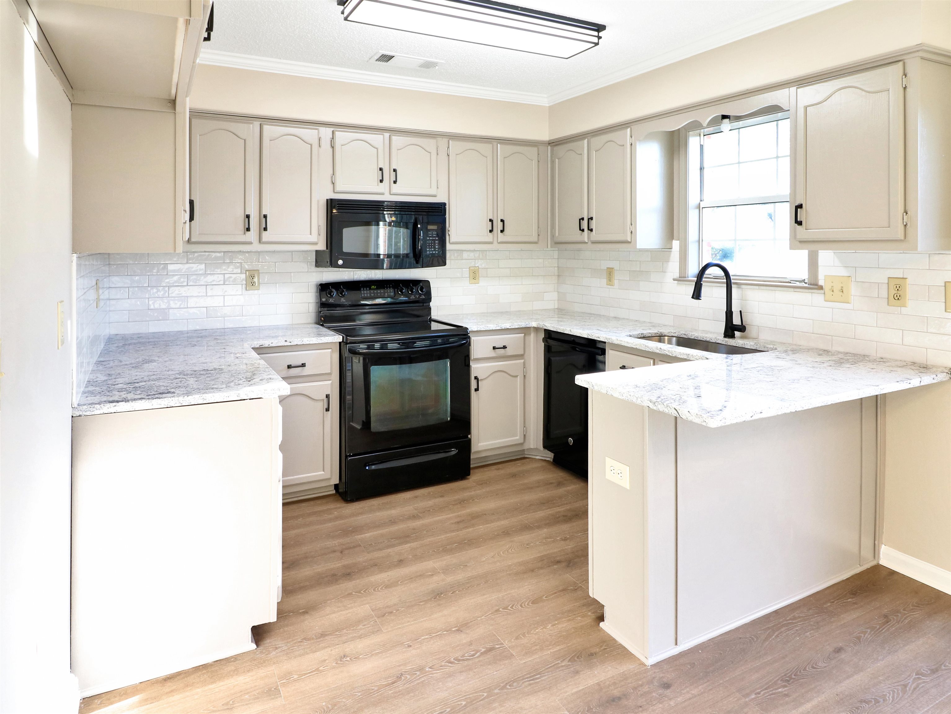 2321 Valley Edge Cove Memphis, TN 38016 - Photo 6 of 18 a kitchen with granite countertop white cabinets and appliances