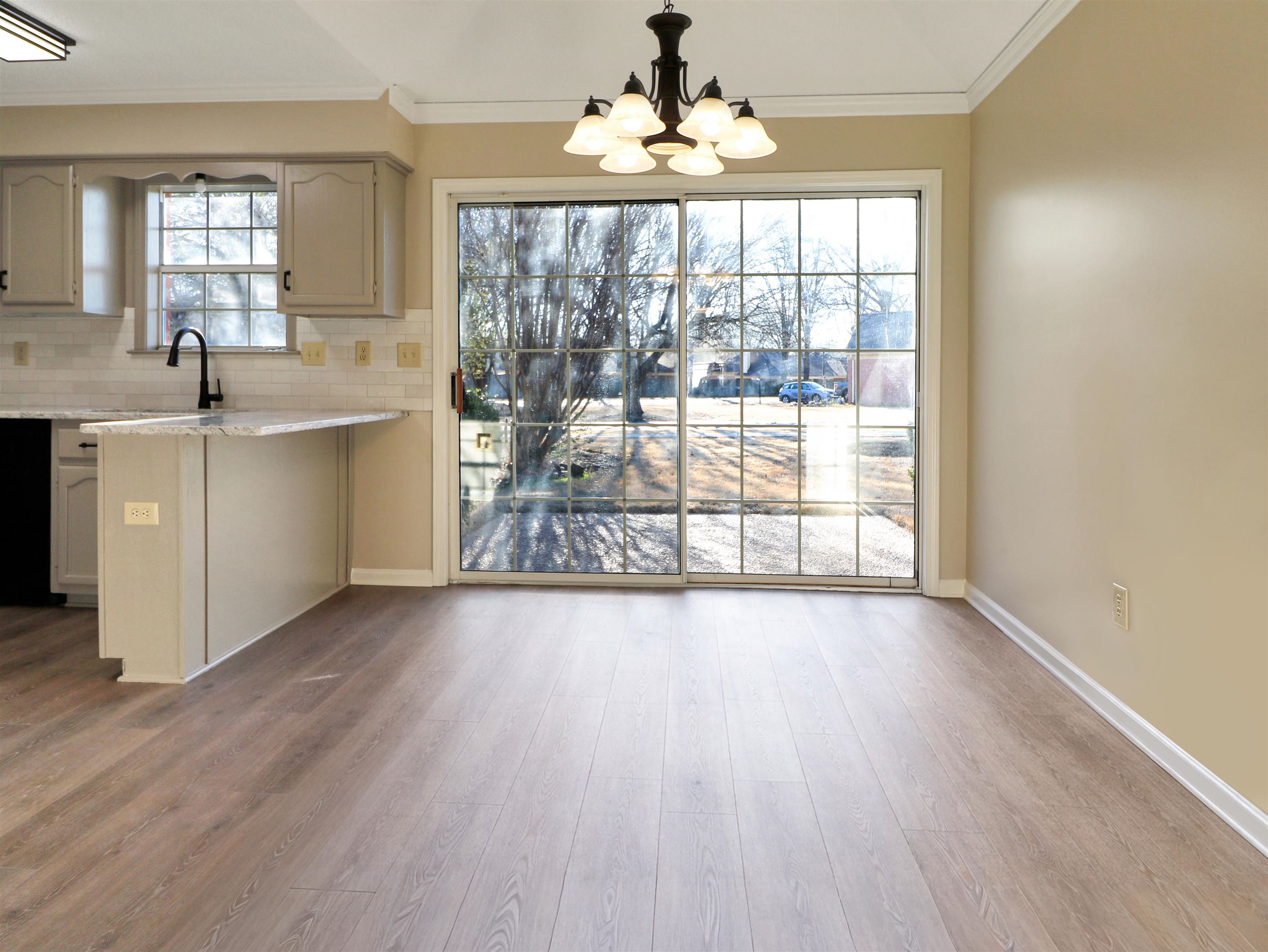 2321 Valley Edge Cove Memphis, TN 38016 - Photo 8 of 18 a view of a big room with wooden floor windows and chandelier
