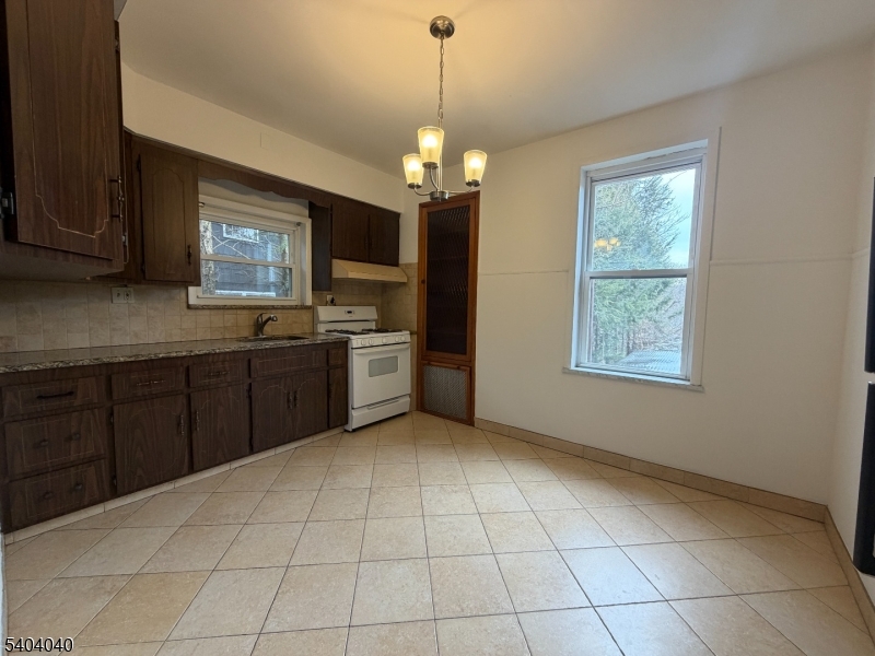 106 Glenridge Avenue, Unit 2 Glen Ridge, NJ 07028 - Photo 1 of 9 a kitchen with stainless steel appliances a sink window and cabinets