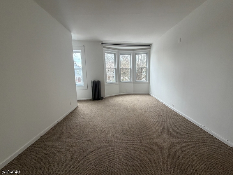 106 Glenridge Avenue, Unit 2 Glen Ridge, NJ 07028 - Photo 7 of 9 a view of an empty room with a window
