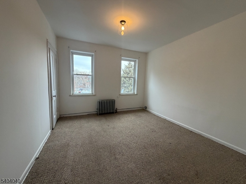 106 Glenridge Avenue, Unit 2 Glen Ridge, NJ 07028 - Photo 8 of 9 an empty room with windows