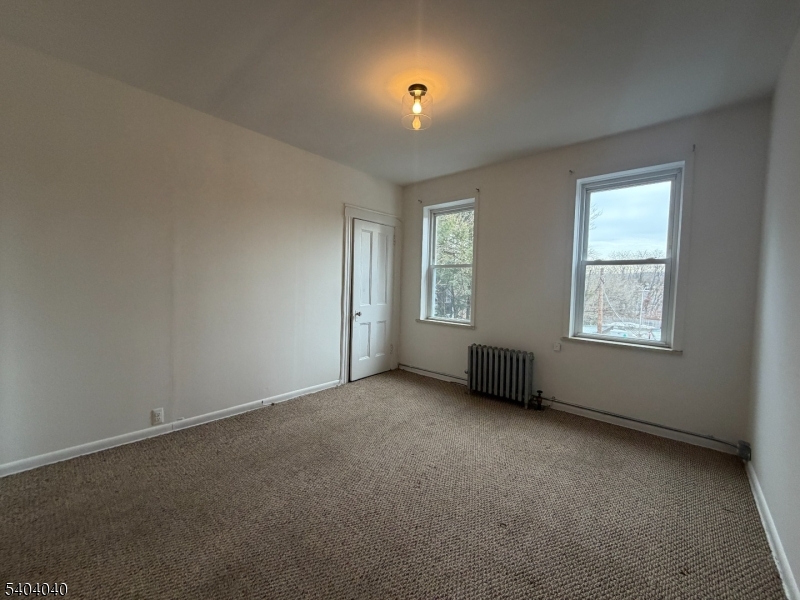 106 Glenridge Avenue, Unit 2 Glen Ridge, NJ 07028 - Photo 9 of 9 an empty room with a window