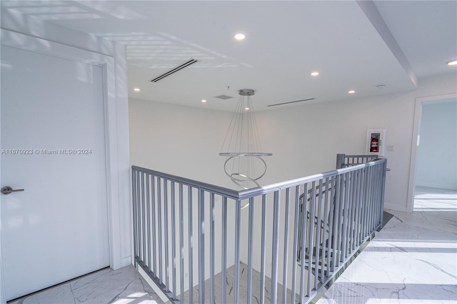 8425 Crespi Boulevard, Unit TH4 Miami Beach, FL 33141 - Photo 18 of 26 a view of a hallway with stairs