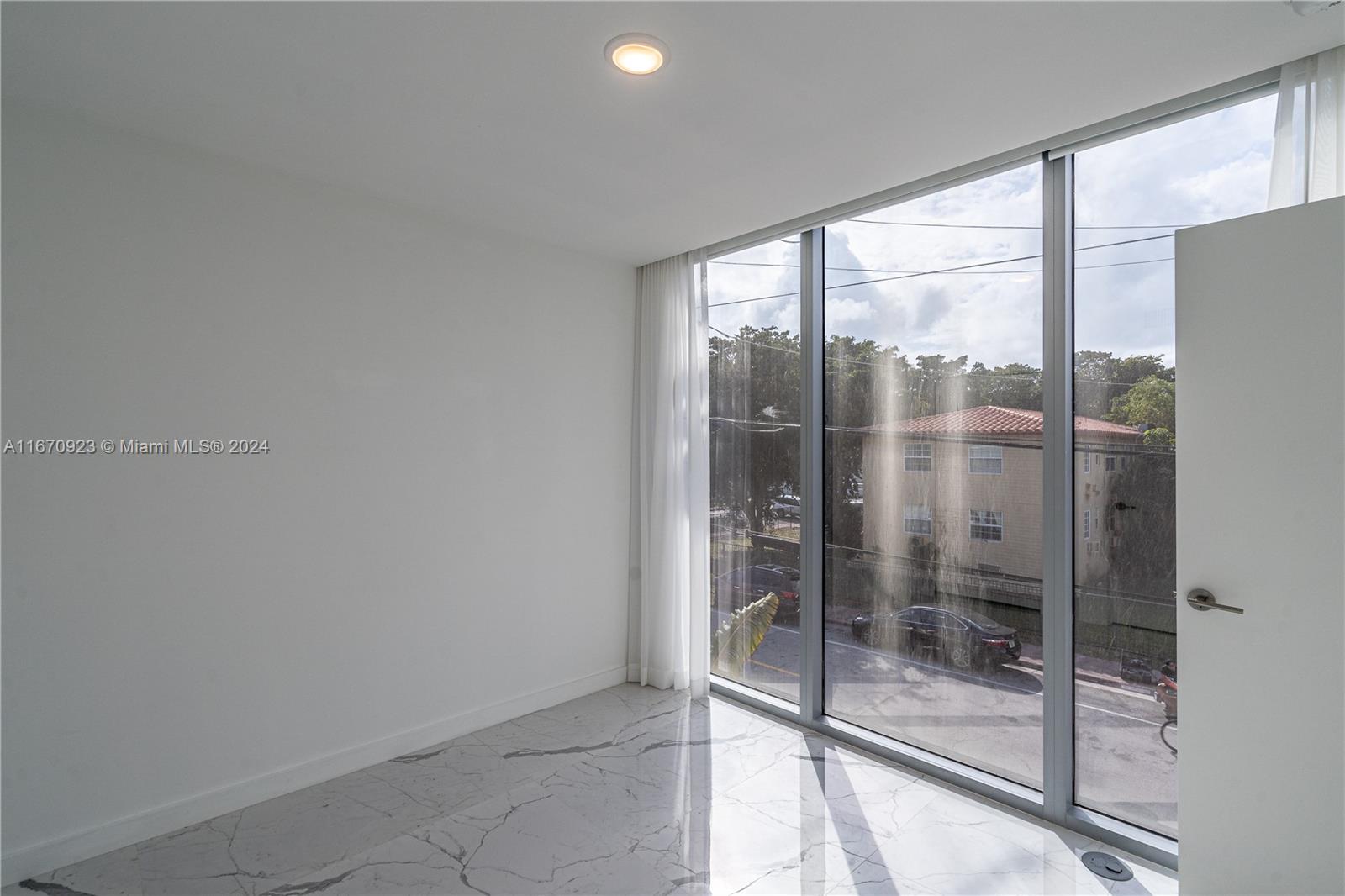 8425 Crespi Boulevard, Unit TH4 Miami Beach, FL 33141 - Photo 22 of 26 a bathroom with a glass shower door