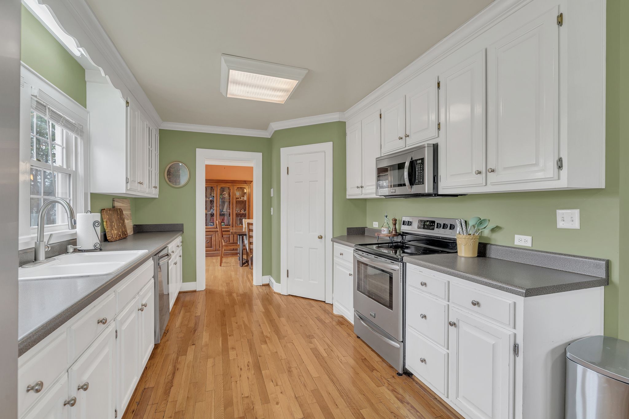 109 Audubon Road Shelbyville, TN 37160 - Photo 17 of 34 a kitchen with stainless steel appliances a stove top oven a sink a refrigerator white cabinets and wooden floor