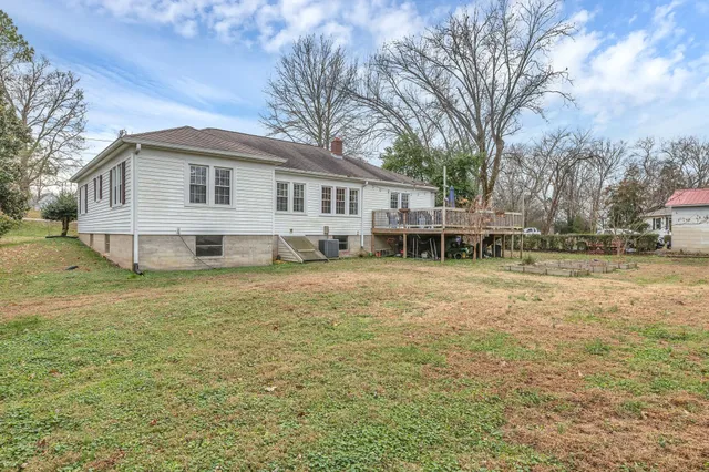 a view of a house with a yard and sitting area